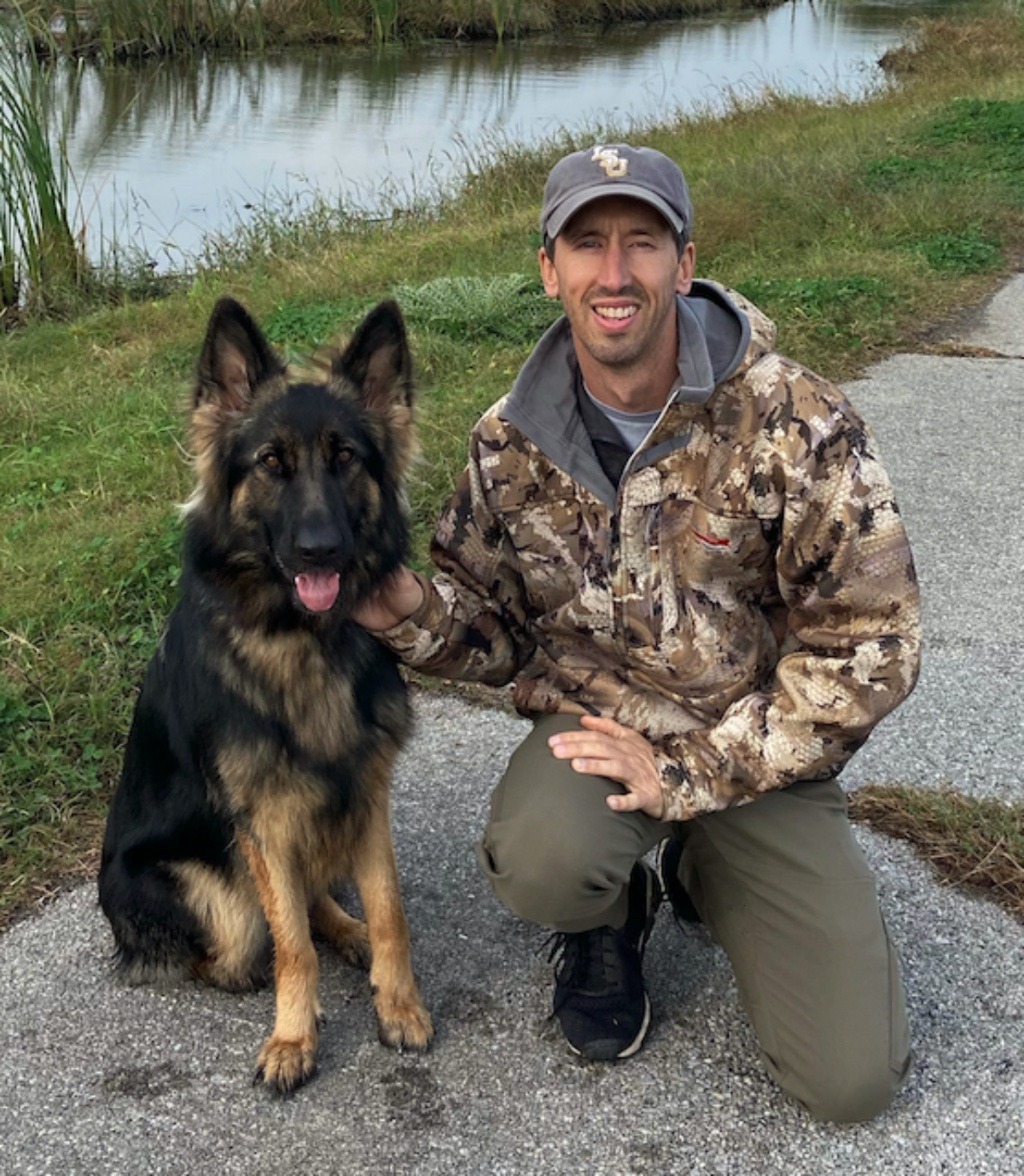 Brandon Taylor with his dog outdoors